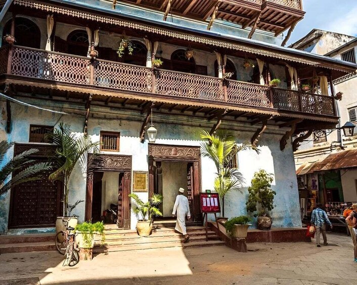 A traditional building with ornate balconies and a signboard. 5