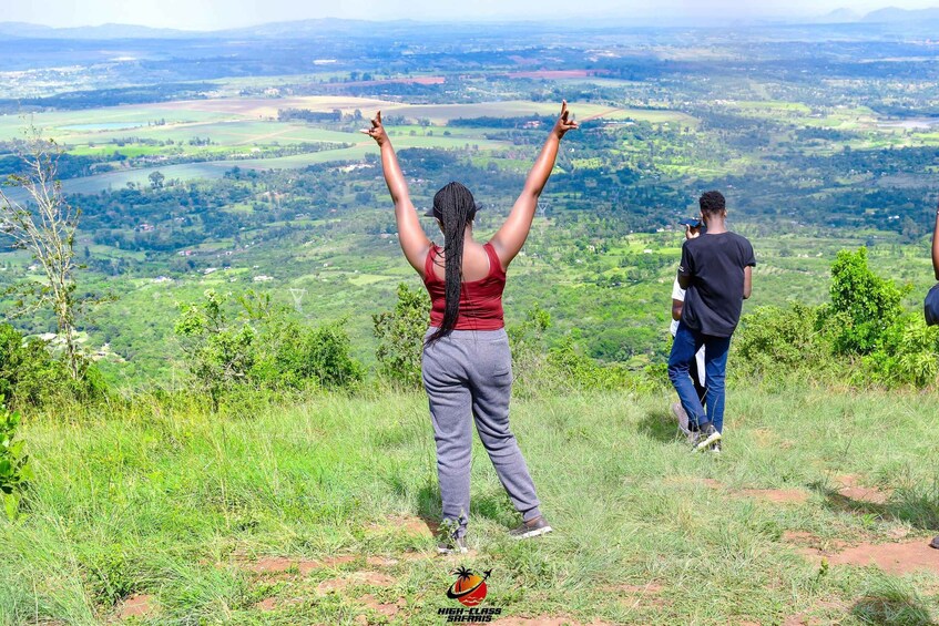 A person with raised arms and another person taking a photo. 5