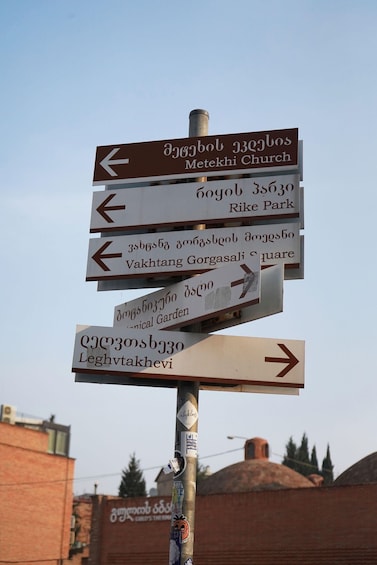 A directional signpost with multiple arrows pointing to various destinations. 2