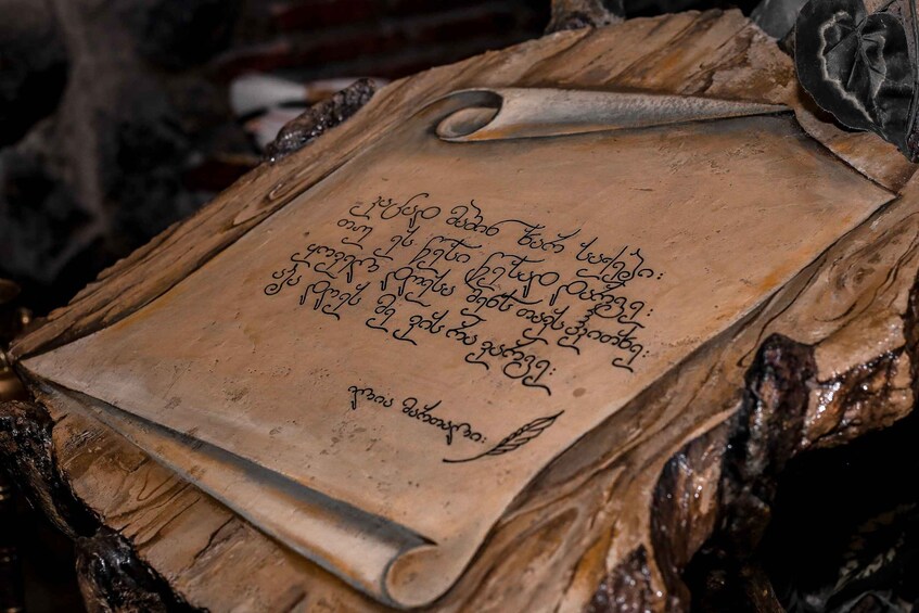 A scroll with handwritten text on a wooden surface. 1