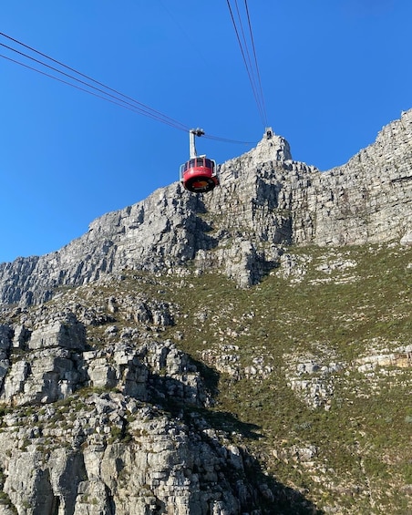 A cable car ascending a rocky mountain. 3