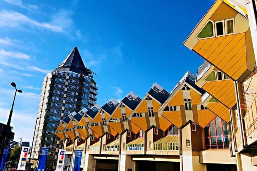 A row of yellow houses with a tall building in the background. 1