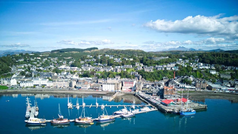 A coastal town with a harbor, boats, and buildings. 3