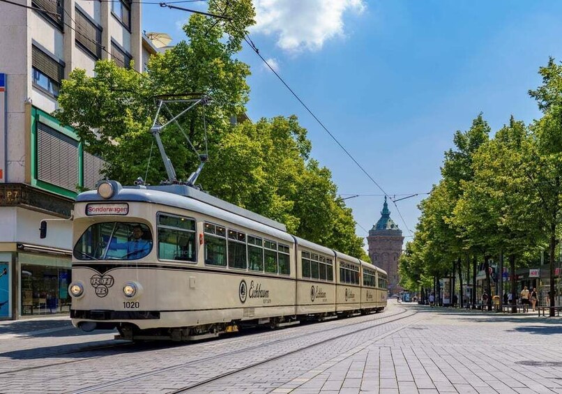 A vintage tram with the number 1020 on a city street. 1