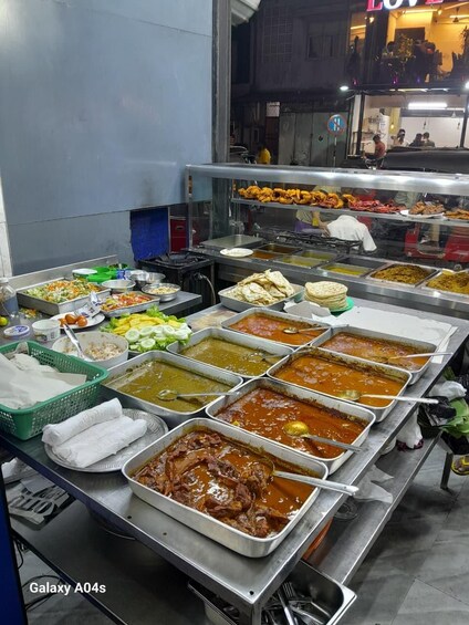 A buffet with various dishes including salads, meats, and sauces. 3
