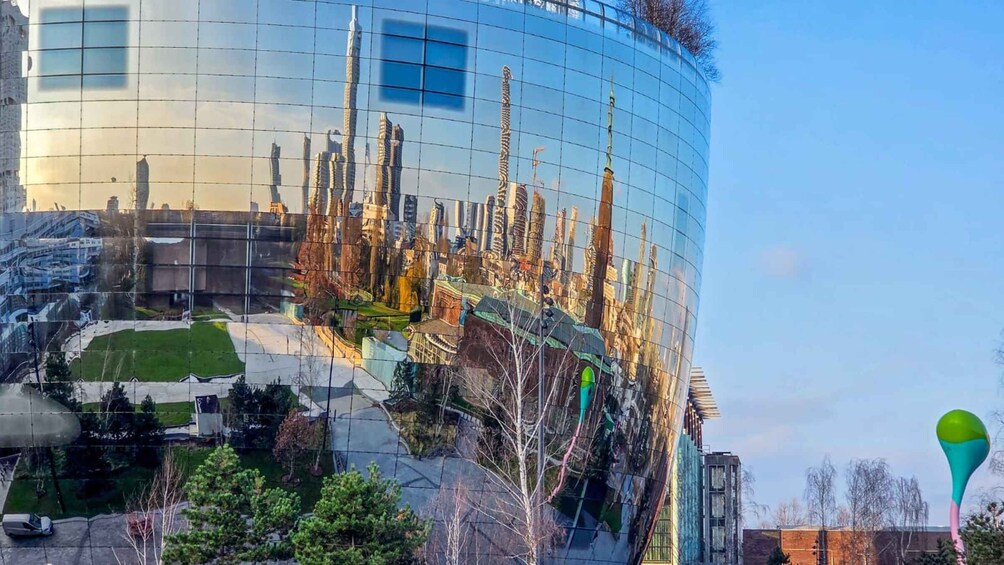 A modern building with a reflective glass facade. 3