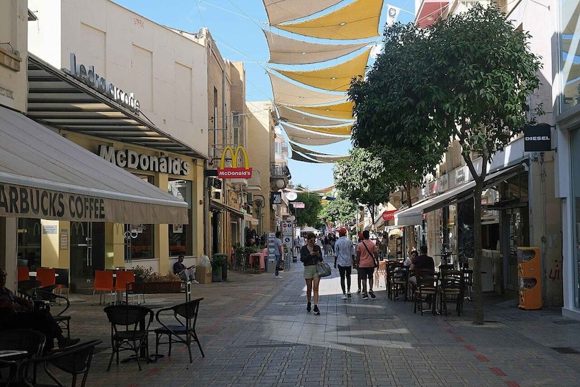 A pedestrian street lined with shops including a McDonald's and Starbucks. 2