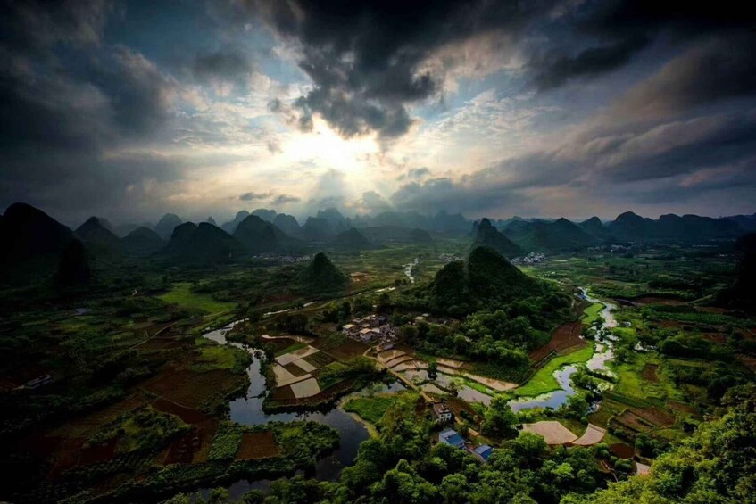 A mountainous landscape with terraced fields and a river. 5