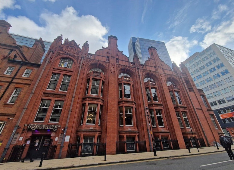 A red brick building with ornate architectural details and large windows. 2