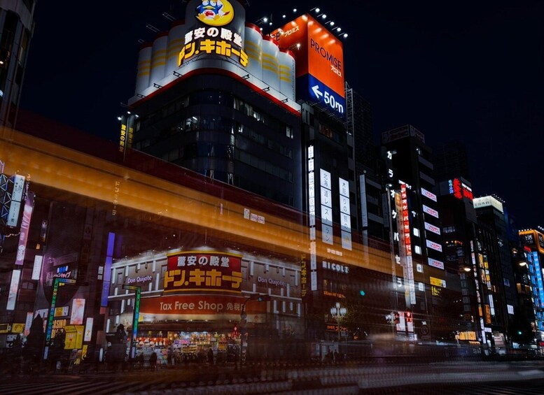 A brightly lit building with signs in Japanese, including one for a tax-free shop. 2