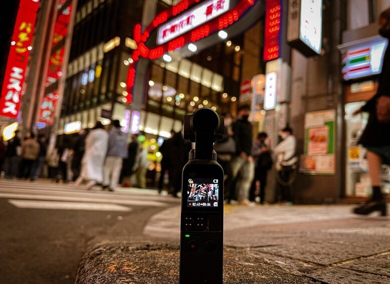 A smartphone with a camera lens on a street corner. 1