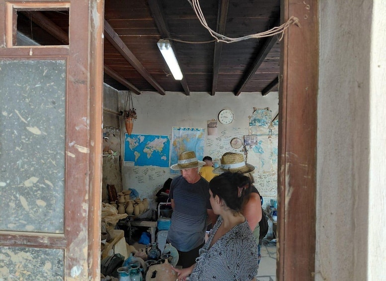 A rustic interior with pottery and a world map on the wall. 4