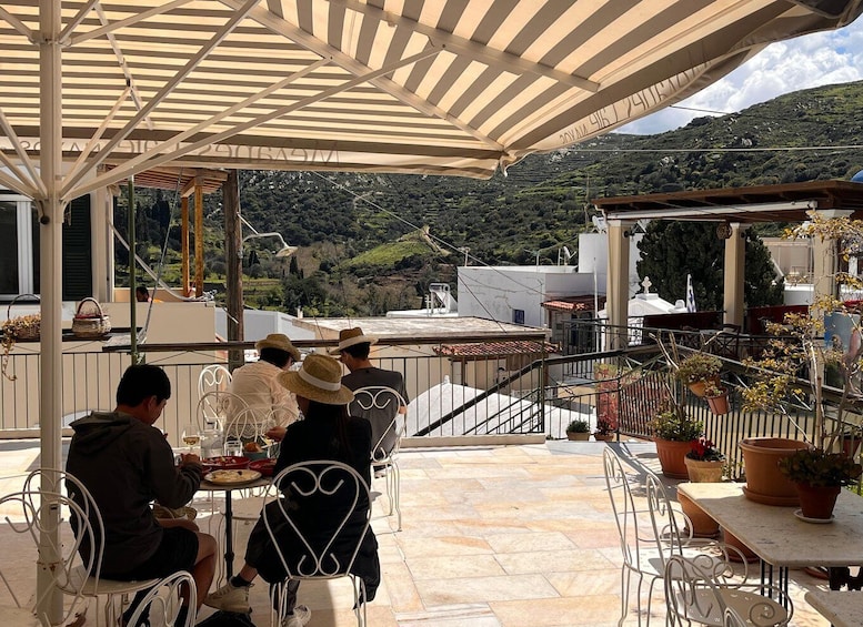 A terrace with outdoor seating, overlooking a hilly landscape. 1