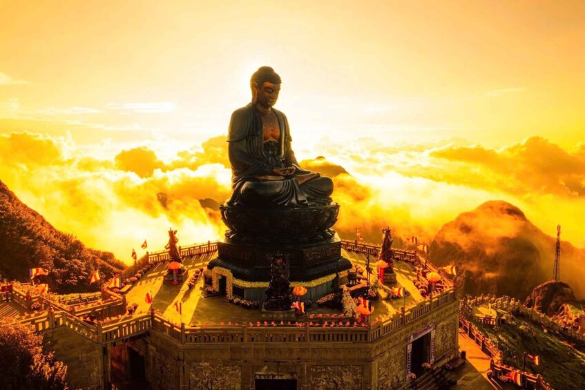 A large Buddha statue on a pedestal surrounded by a temple complex. 2