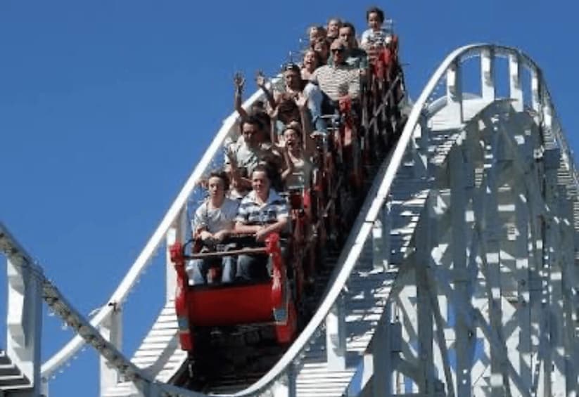 A roller coaster with passengers seated in rows. 1