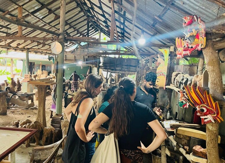 A rustic market with wooden structures and traditional masks. 5