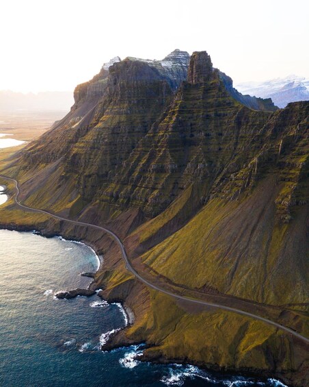 A coastal mountain range with a winding road along the cliffs. 3