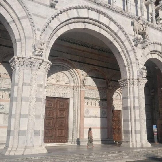 An ornate building with intricate stonework and large wooden doors. 3