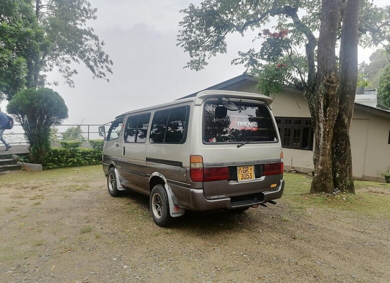 A Toyota van parked on a gravel driveway with a house in the background. 2