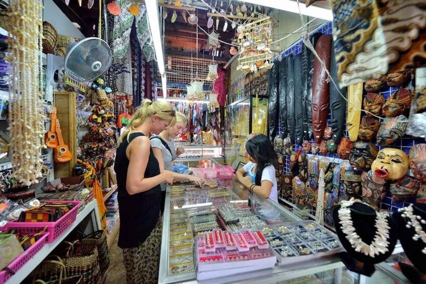 A market stall with various jewelry items and masks. 5