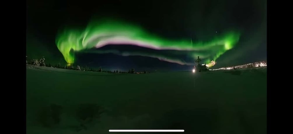 A night scene with the Northern Lights (Aurora Borealis) over a flat landscape. 3