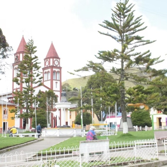 A church with two towers and a statue in front. 4