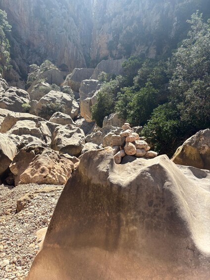 A rocky landscape with large boulders and sparse vegetation. 2