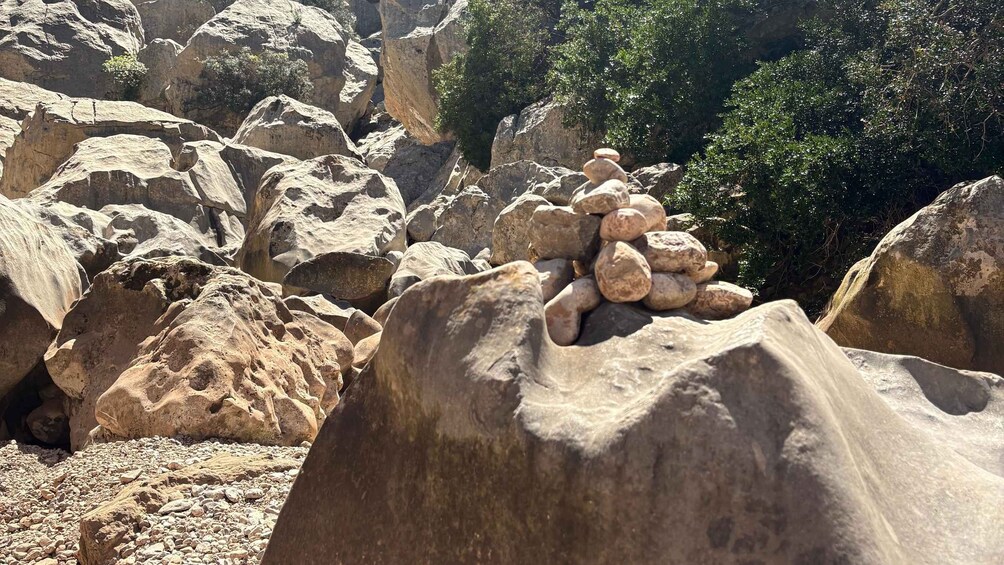 A rocky landscape with large boulders and a pile of stones. 2