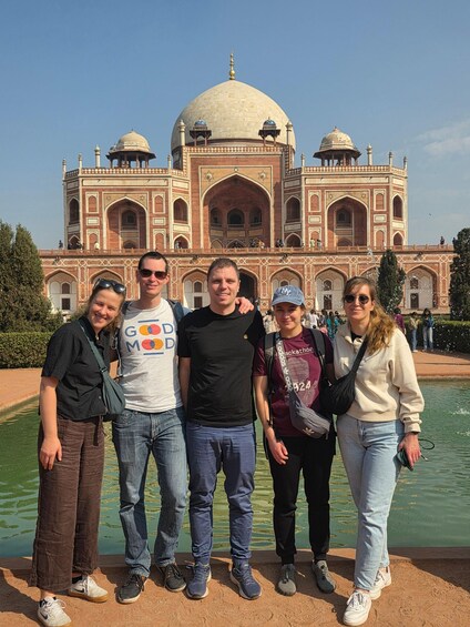 A group of people standing in front of the Taj Mahal. 3