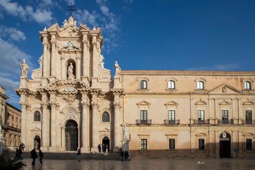 A historic building with ornate architecture, including statues and detailed carvings. 4