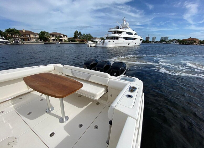 A boat with a wooden table and two outboard motors on the water. 4