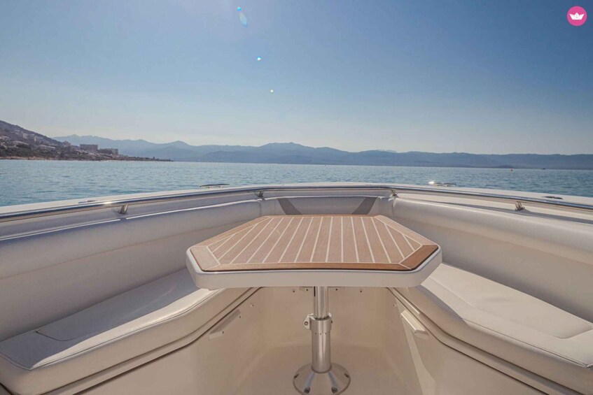 A boat's interior with a table and seating. 5