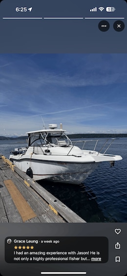 A white boat docked at a wooden pier with a clear blue sky in the background. 2
