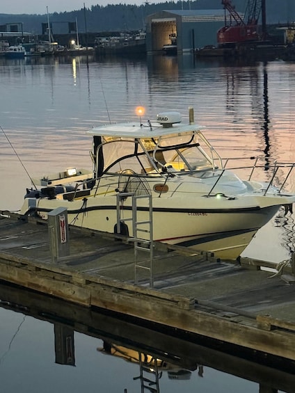 A boat docked at a pier with a calm water body in the background. 1