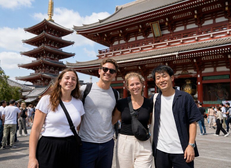 A group of people in front of a traditional Japanese pagoda with multiple tiers. 4