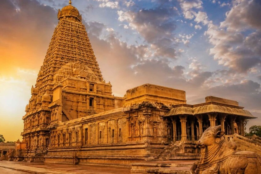 A temple with a large spire, intricate carvings, and a lion statue. 1