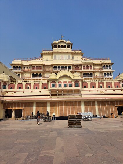 A large, multi-story building with intricate architectural details and a spacious courtyard. 2