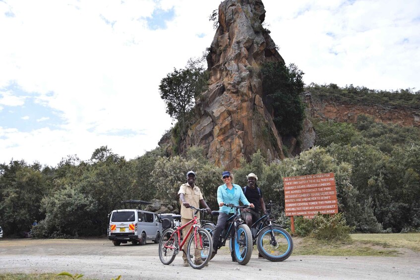 A rocky outcrop with a sign warning about climbing safety. 2