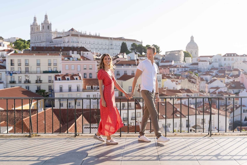 A couple walking on a rooftop with a cityscape in the background. 3