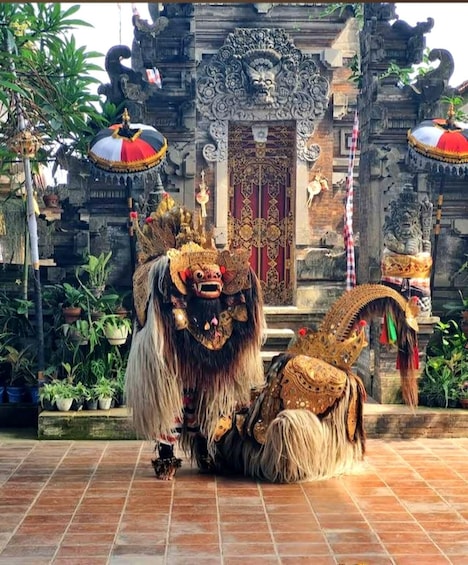 A traditional Balinese dance performance with elaborate costumes and a temple backdrop. 4