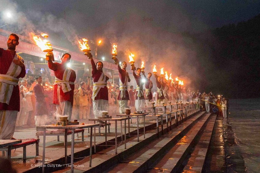 A nighttime procession with individuals carrying flaming torches. 2