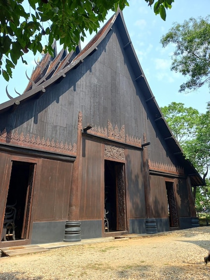 A traditional wooden building with a steep roof and decorative carvings. 5