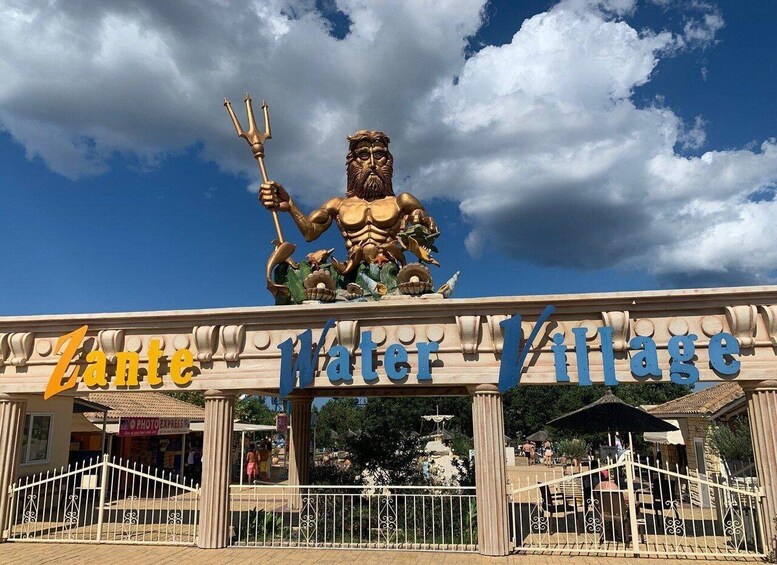 A large statue of a muscular figure holding a trident, with the words "Zante Water Village" beneath it. 4