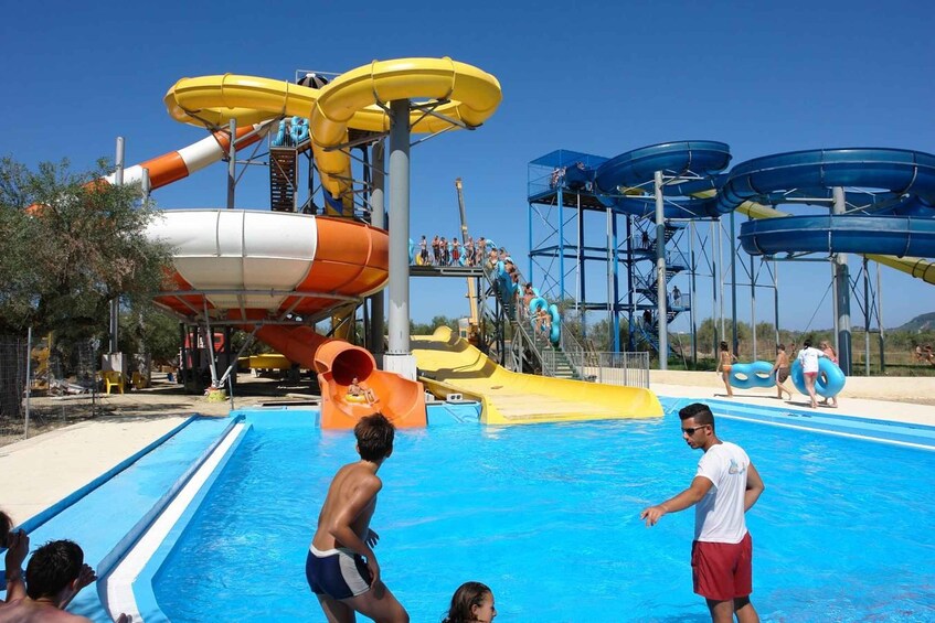 A water park with multiple water slides and a swimming pool. 2