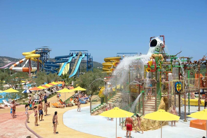 A water park with slides, water features, and umbrellas. 1