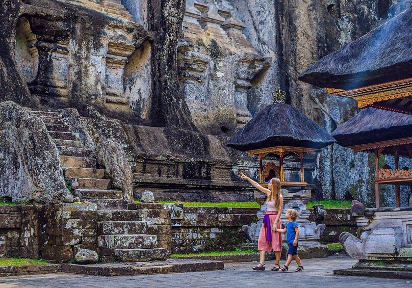 A temple with stone steps and a golden statue. 2