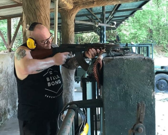 A person aiming a shotgun at a target. 3