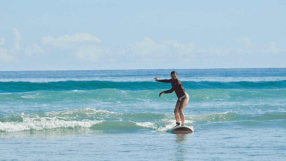 A person surfing on a wave in the ocean. 1