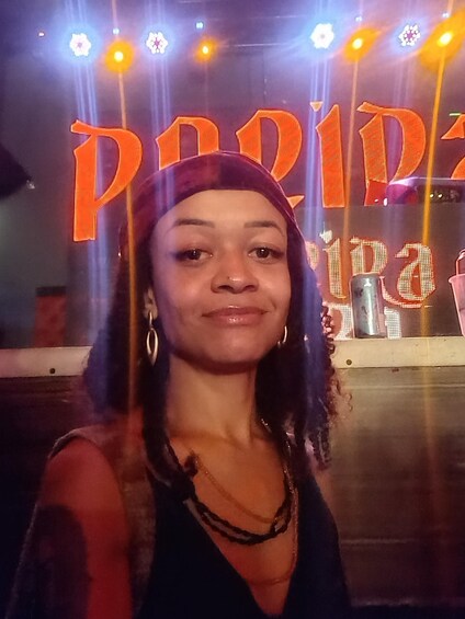 A person in front of a brightly lit sign with the word 'PARIS' in large letters. 3