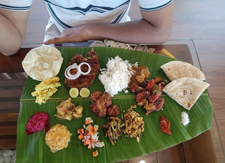A variety of South Indian dishes served on a banana leaf. 3